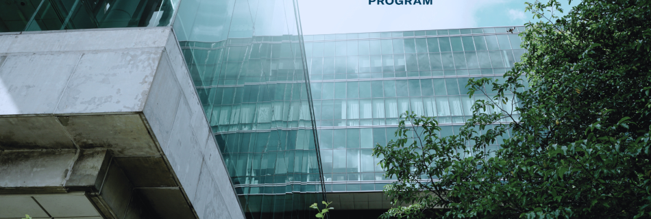 An office building surrounded by lush trees and a BOMA BEST logo at the top.