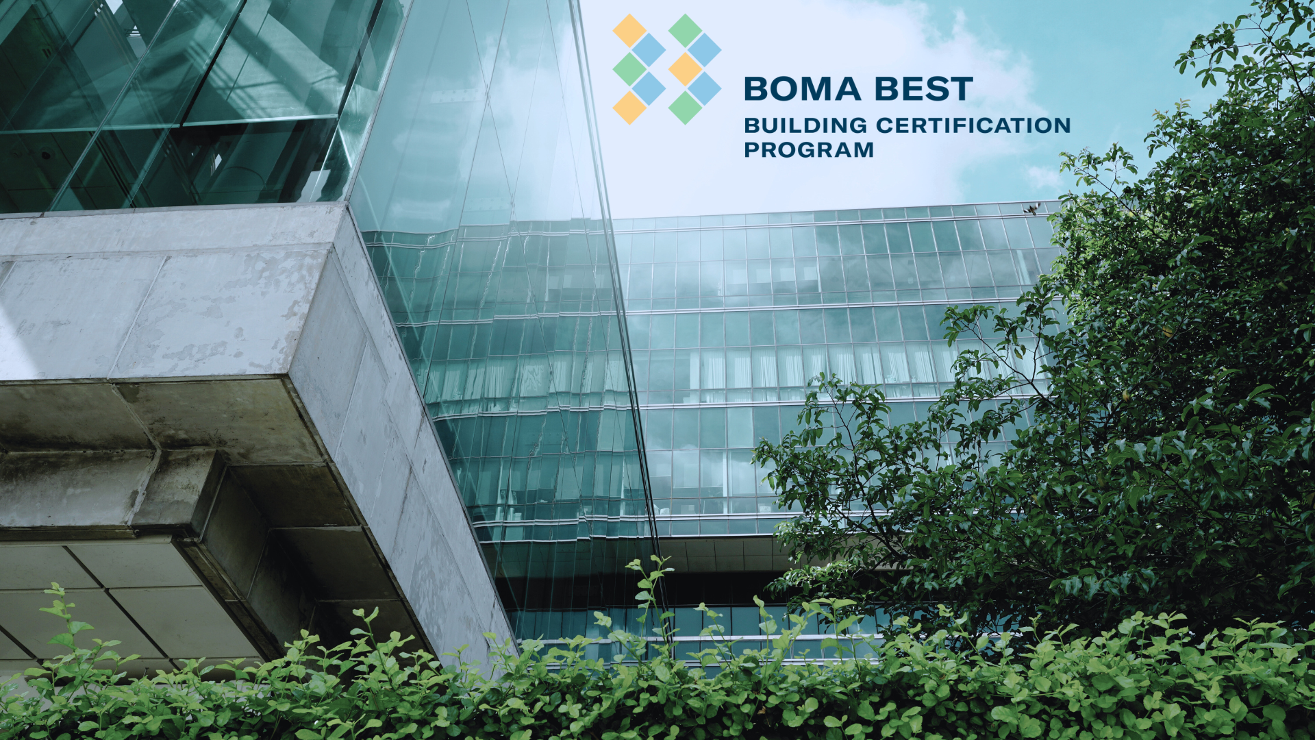An office building surrounded by lush trees and a BOMA BEST logo at the top.